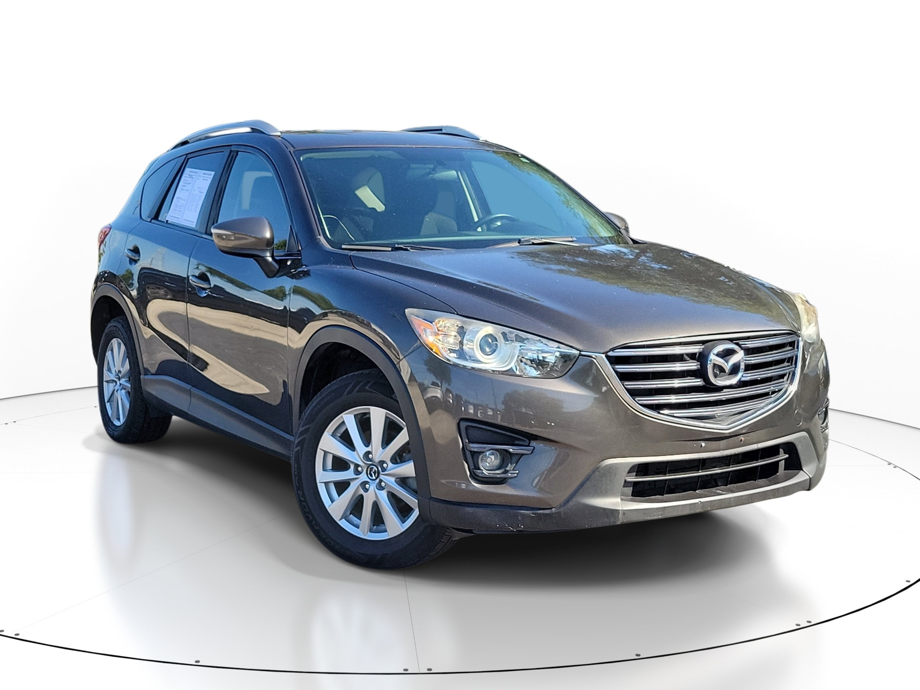 2016 Mazda Mazda CX-5 Touring in Titanium Flash Mica — front three-quarter view