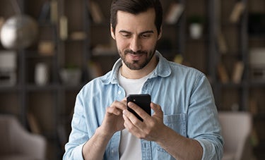 image of a man looking at a phone